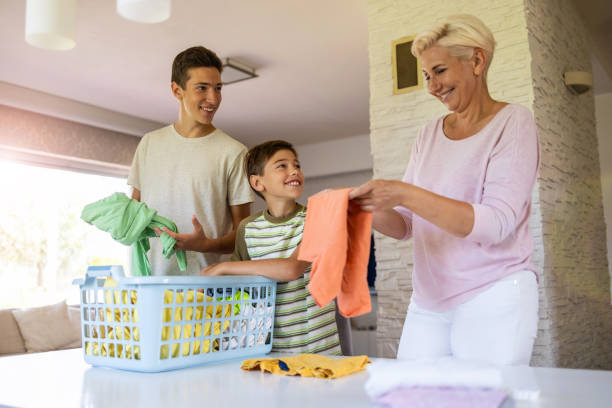 Mother and sons sorting through laundry together at home